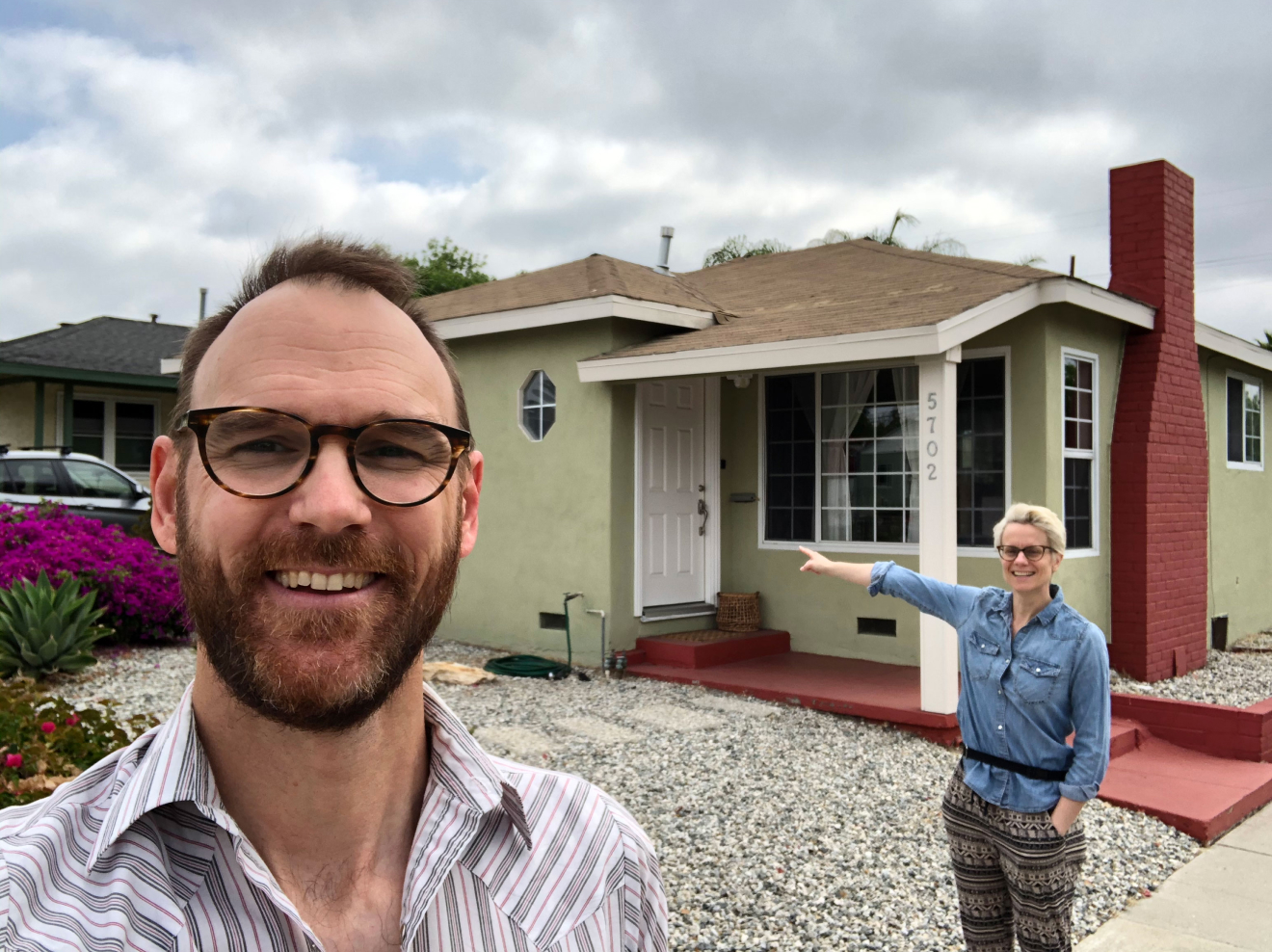 Joe and Monica in front of their house